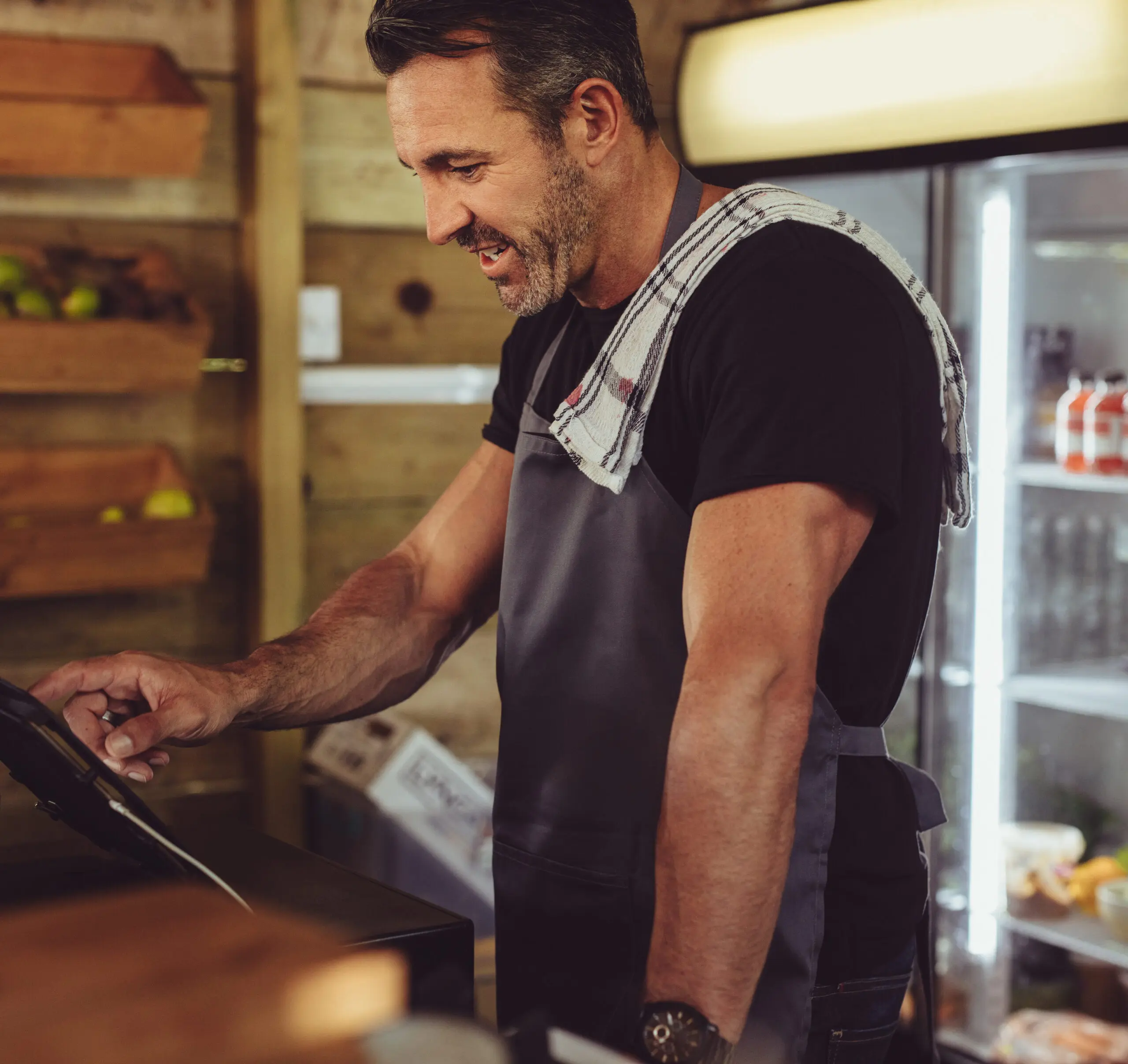 Foodservice operator using a tablet at the counter