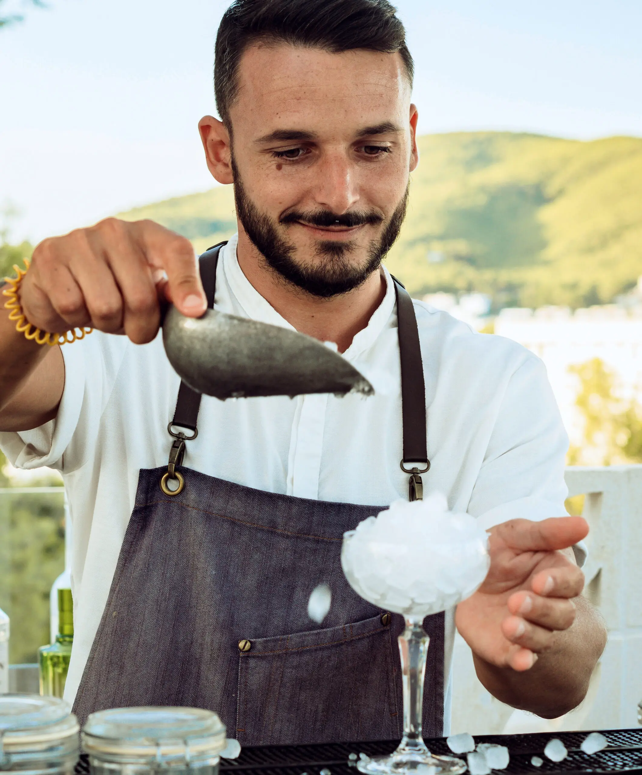 Bartender preparing a cocktail with ice