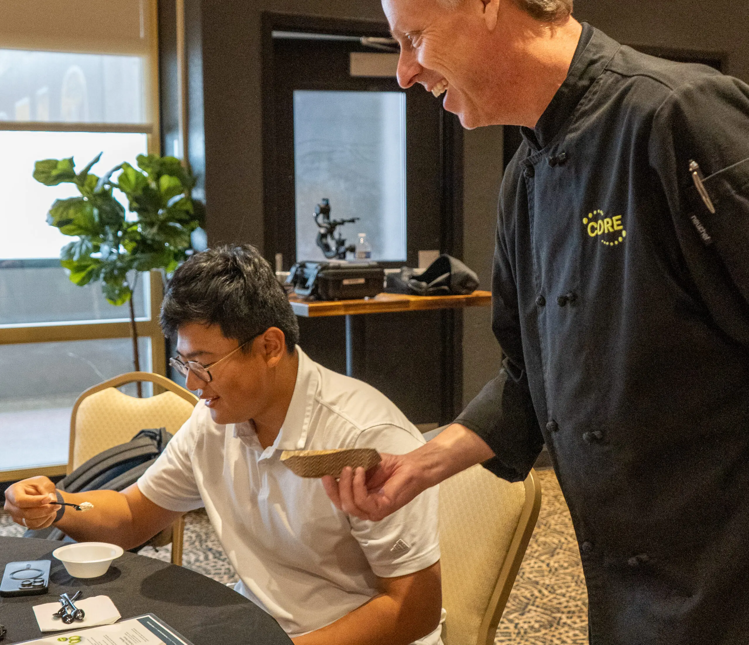 Chef handing a man a food sample to taste test