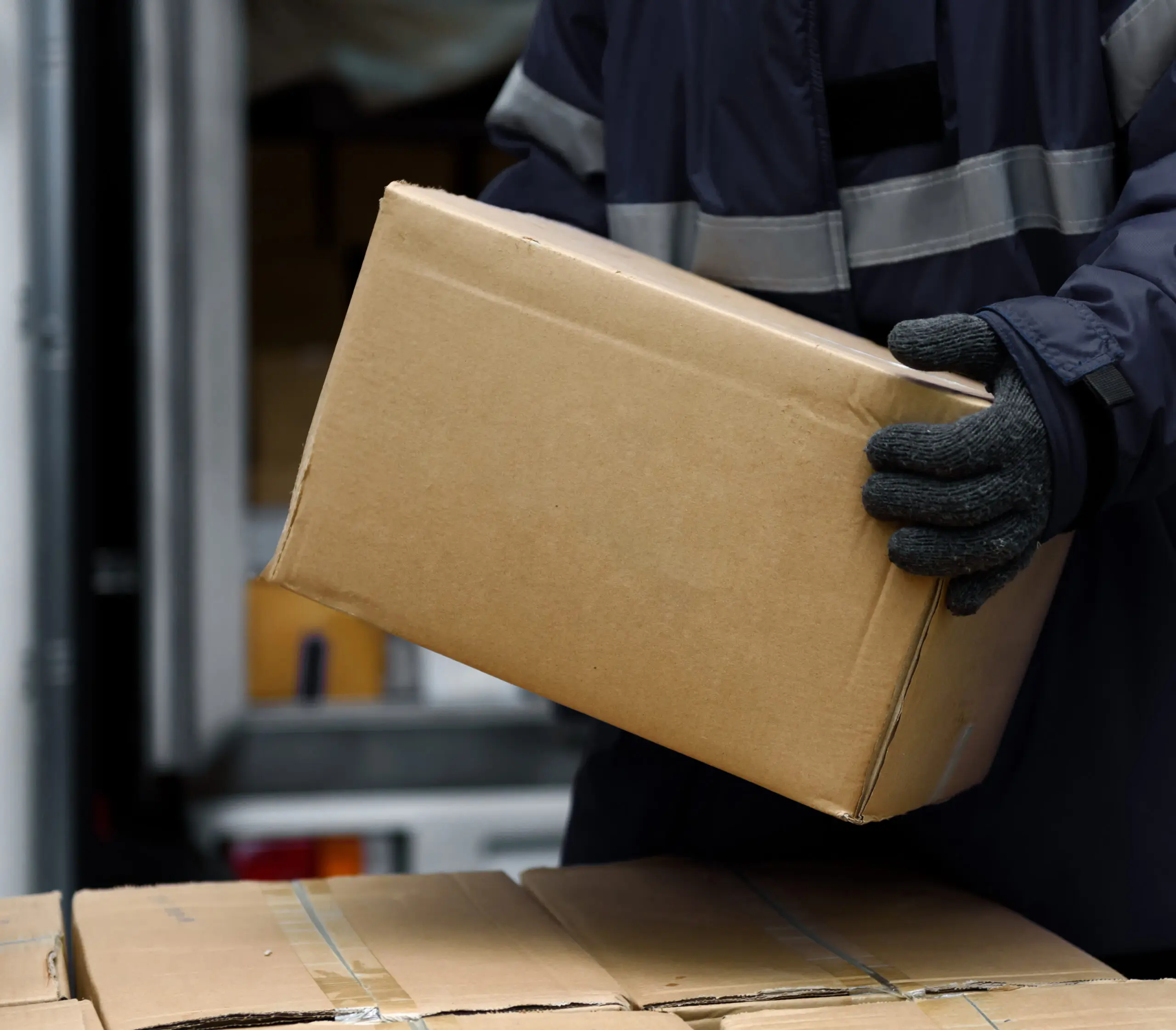 Worker handling a boxed shipment in a CORE warehouse.