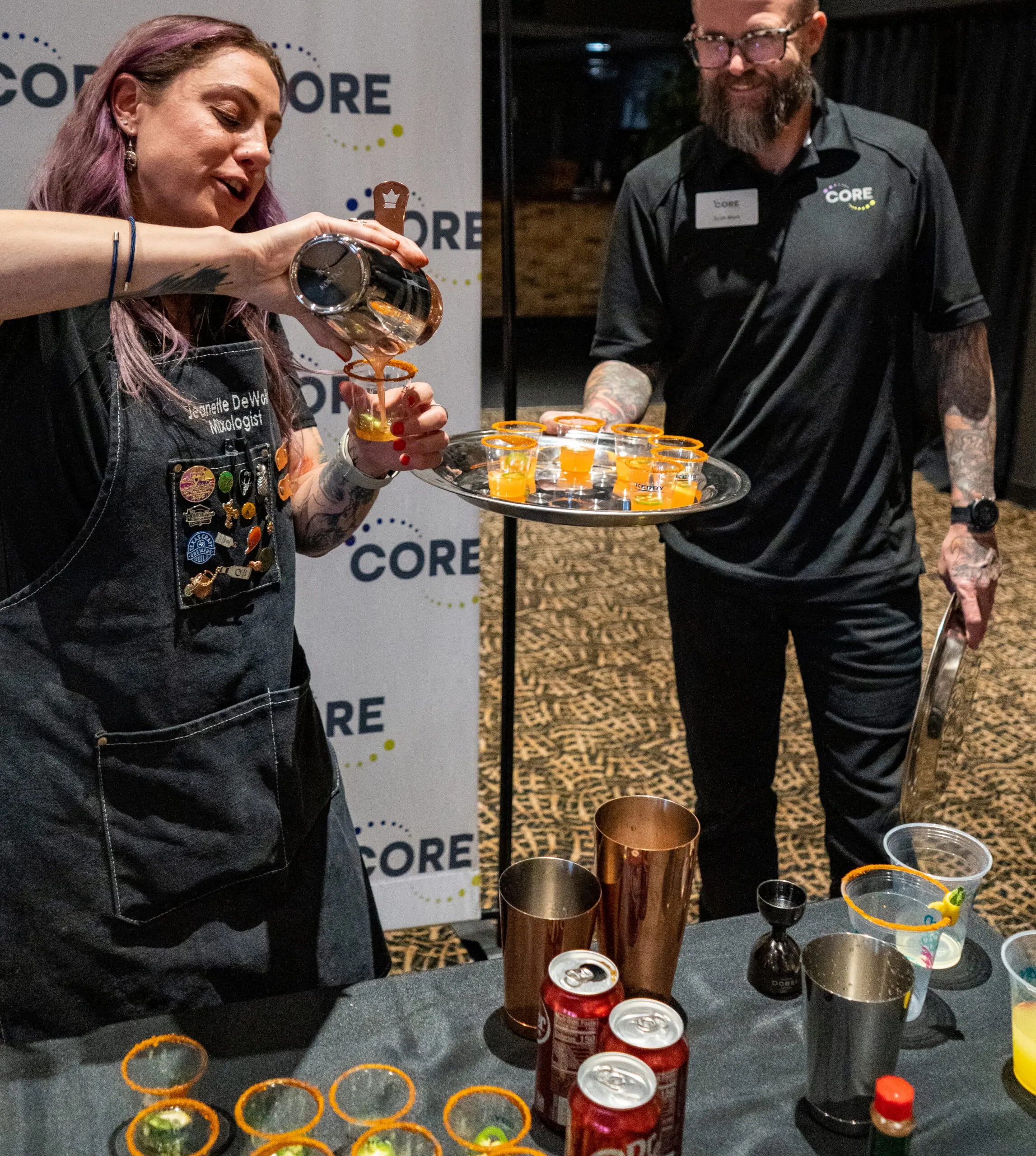 CORE beverage consultants pouring samples at a tasting show.
