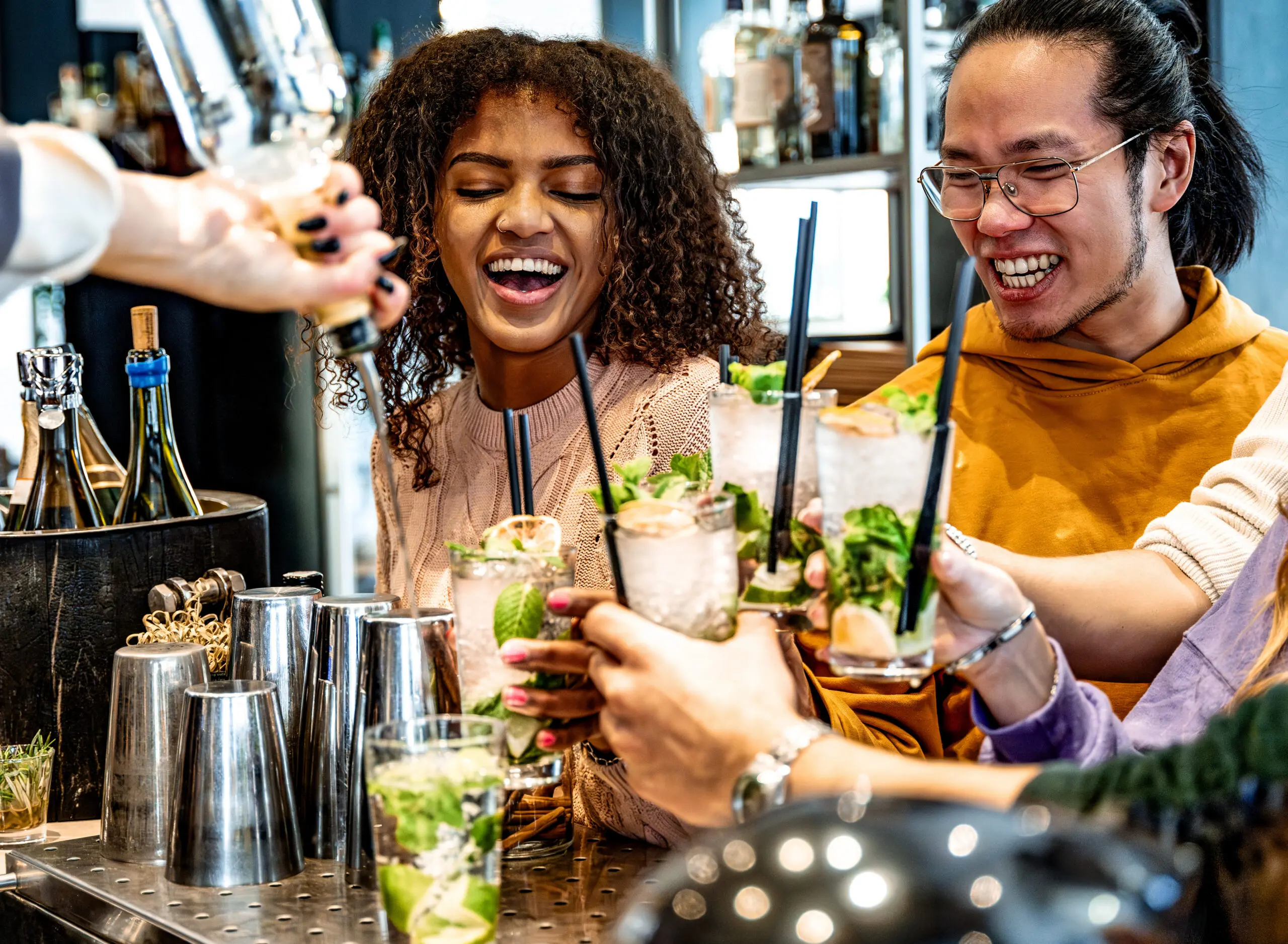 Group at a bar raising handcrafted cocktails