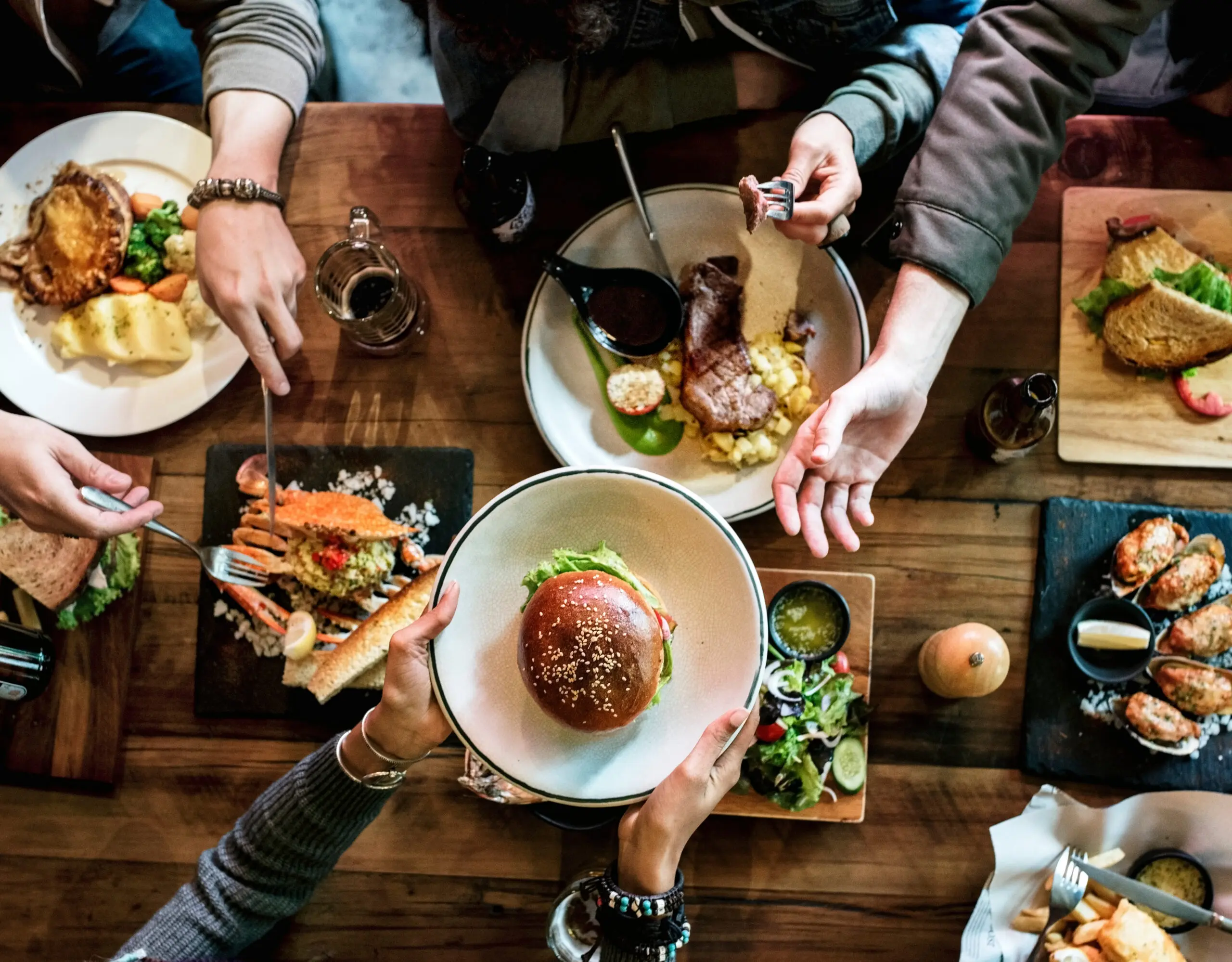 Overhead view of a shared table of plated dishes