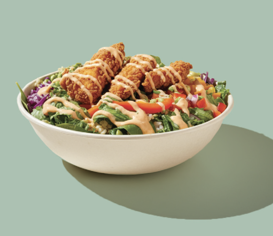Bowl topped with crispy chicken and vegetables